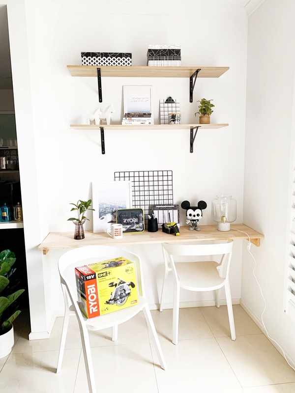 A study nook with a desk and two shelves