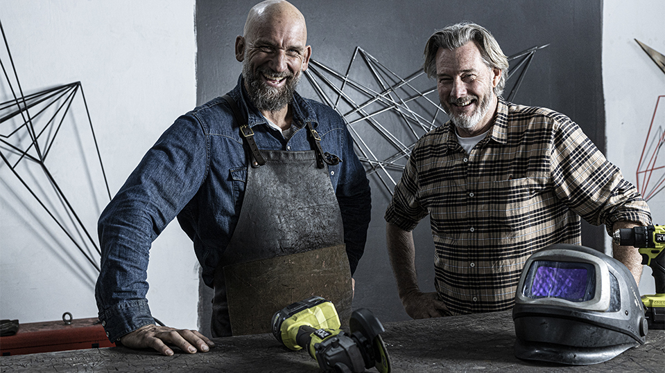 Dion Horstman and Barry DuBois smiling with metal work in background 