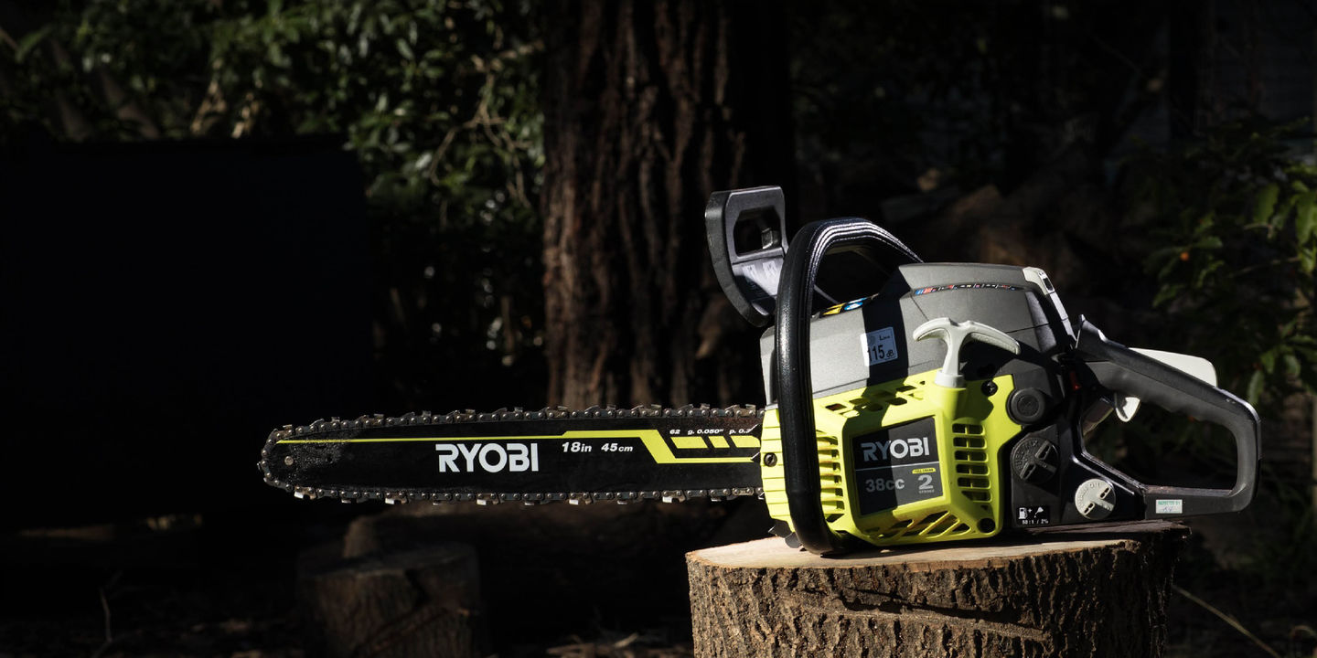 Ryobi chainsaw displayed on a cut log