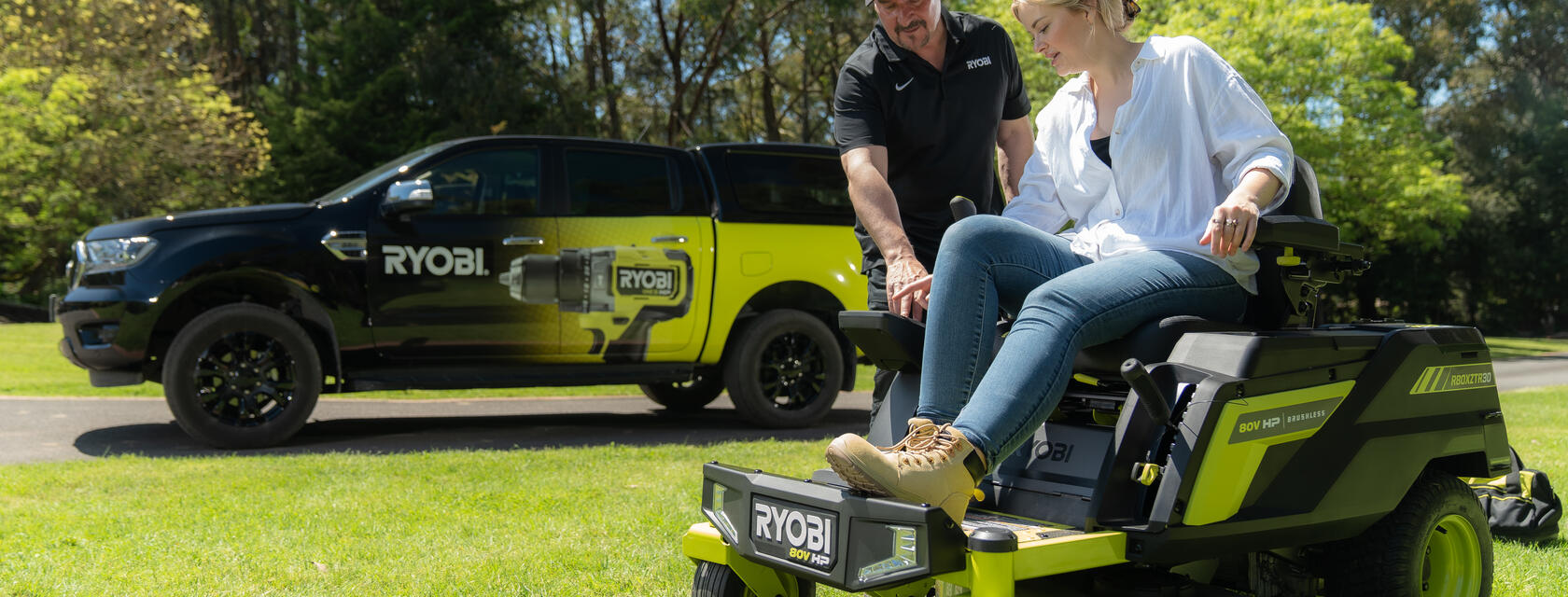 After Sales Support team member assisting a blonde woman with her 80V Ride-on Mower