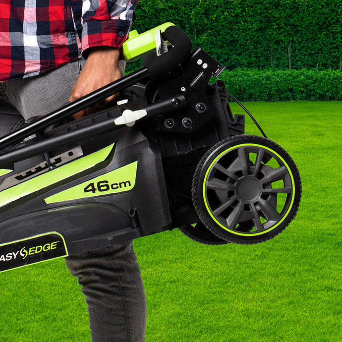 A man carries a Ryobi lawn mower