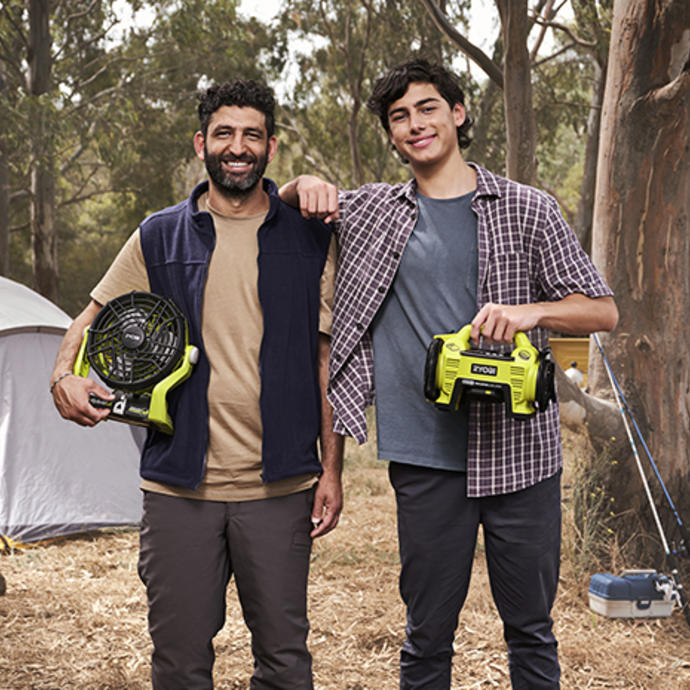 A man uses a RYOBI Impact Driver to secure tent peg